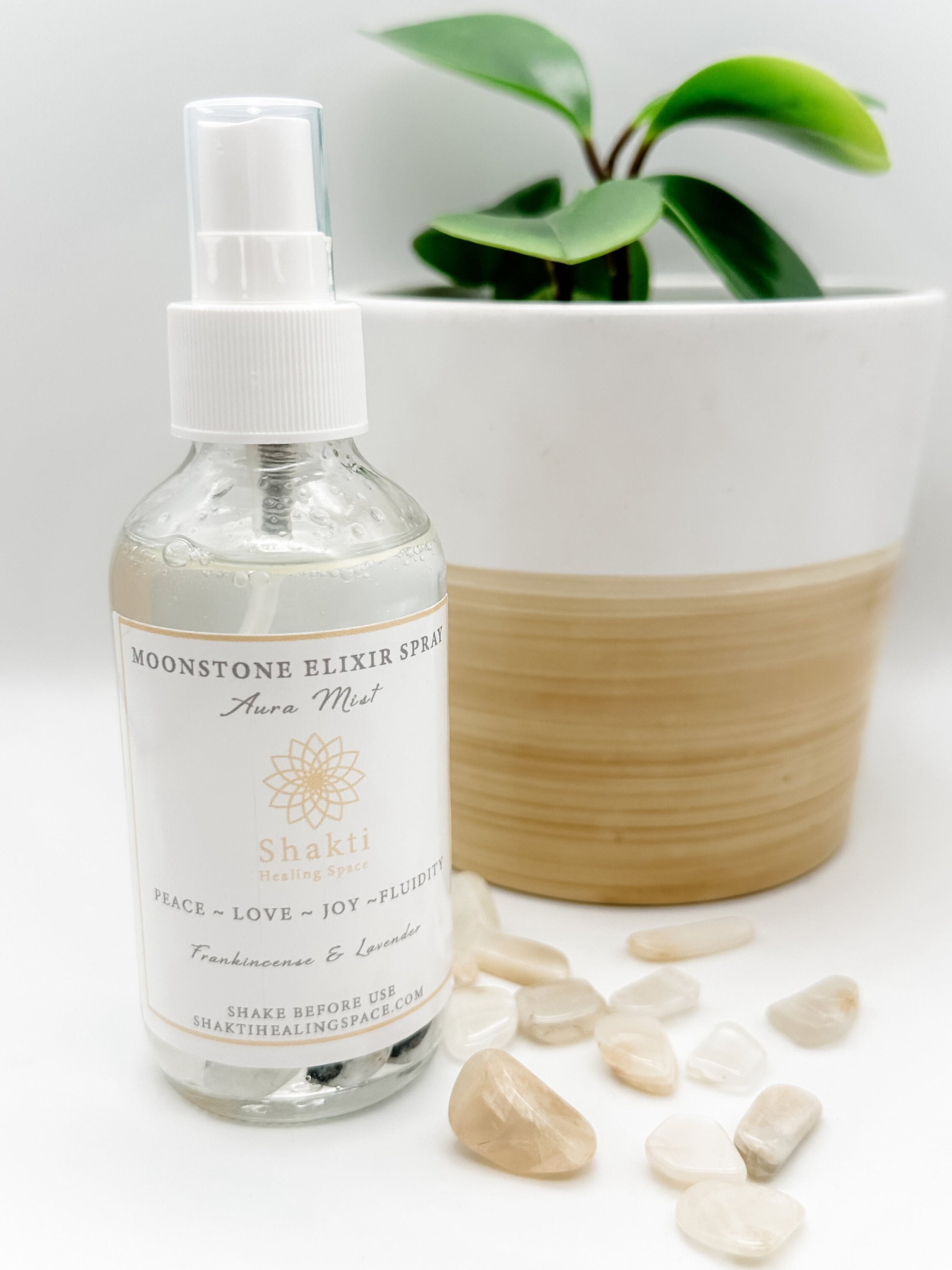 Aromatherapy aura mist spray with moonstone crystals.