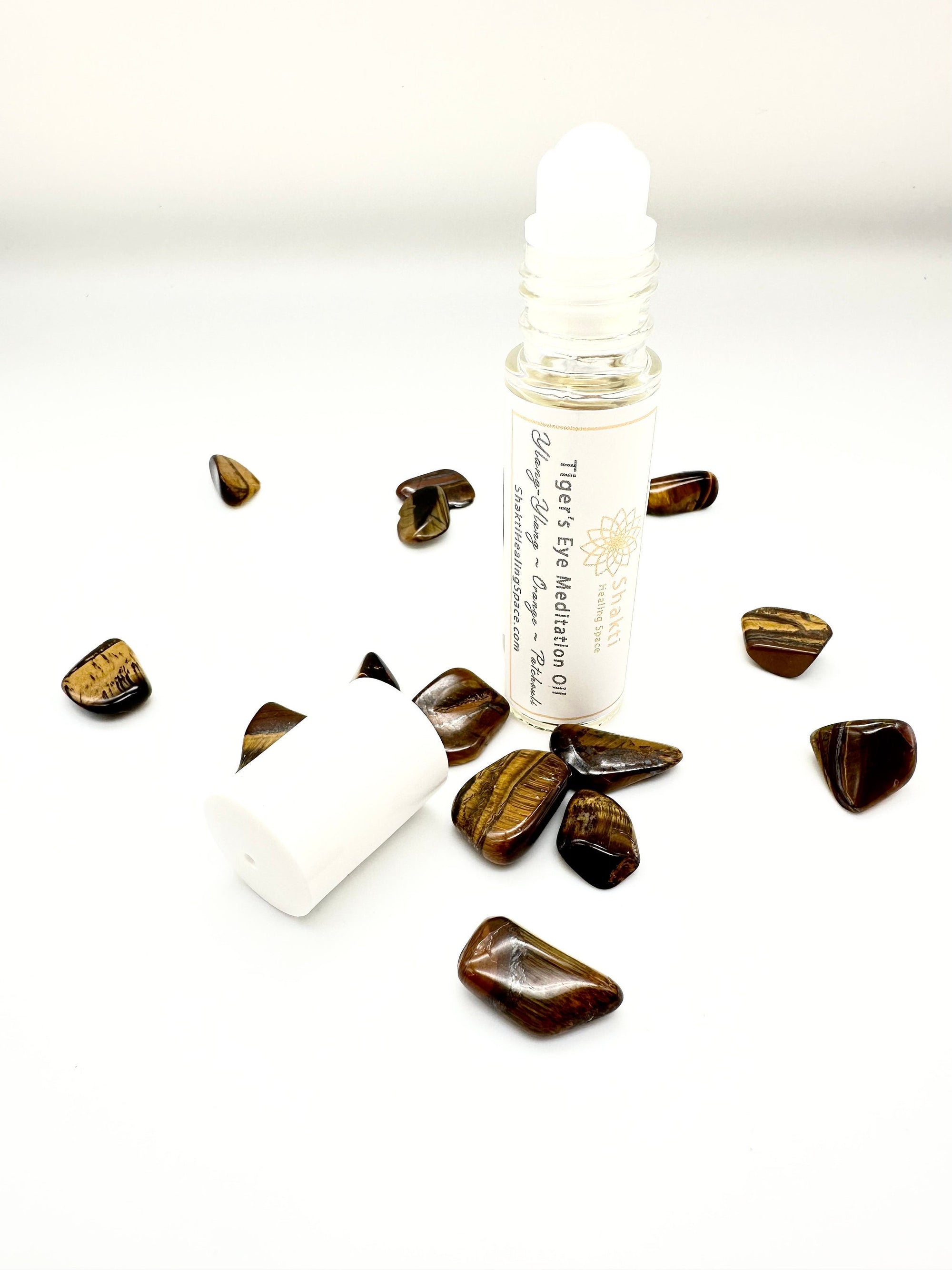 Essential oil roller for solar plexus meditation with tiger's eye stone chips.