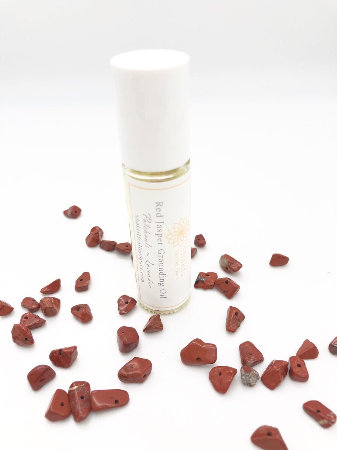 Red Jasper grounding essential oil roller with red jasper chips.