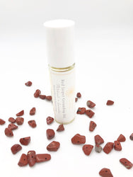 Red Jasper grounding essential oil roller with red jasper chips.