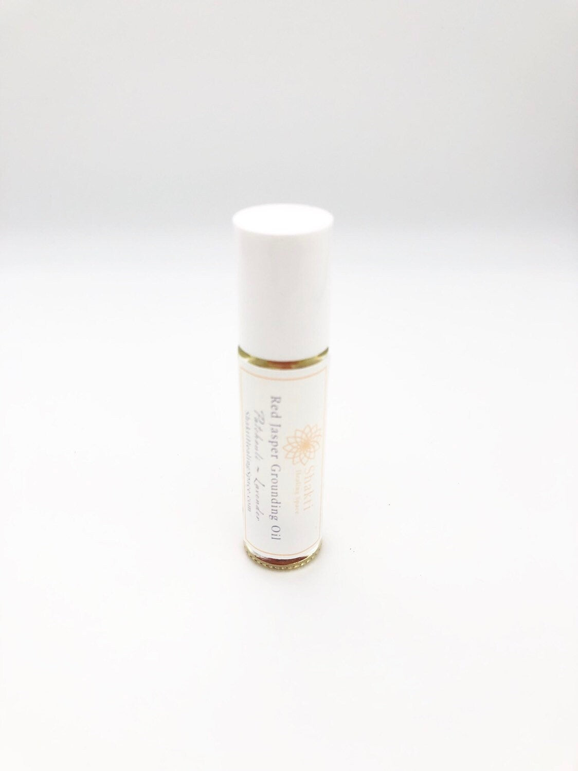 Root chakra grounding essential oil roller.